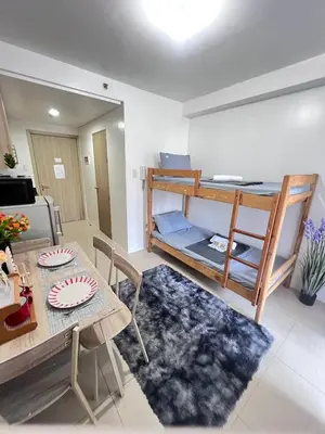 a living room with a table and a bunk bed at UNISTAY Shore Res w Bal Manila Bay View nr MOA in Manila