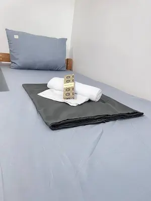 a bed with two towels and a bag on it at UNISTAY Shore Res w Bal Manila Bay View nr MOA in Manila