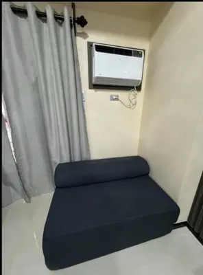 a small room with a couch and a window at JRM Staycation The Radiance Manila Bay Sunset with Pay Parking in Manila