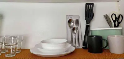 a table with plates and utensils on it at Wowstaycation in Manila