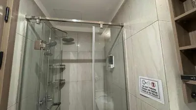a shower with a glass door in a bathroom at L CONDOTEL Apartment Near Okada Casino PITX MOA with Pool in Manila