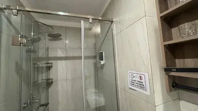a shower with a glass door in a bathroom at L CONDOTEL Apartment Near Okada Casino PITX MOA with Pool in Manila