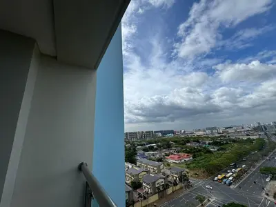 a view of a city from the balcony of a building at L CONDOTEL Apartment Near Okada Casino PITX MOA with Pool in Manila