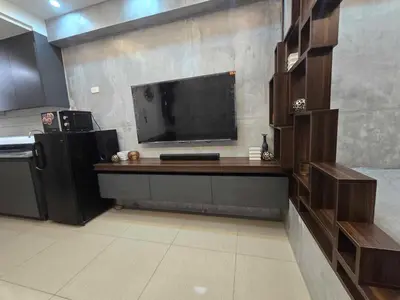 a living room with a large flat screen tv on a wall at Stonewood Suite by Staycationplus with FREE PARKING in Manila