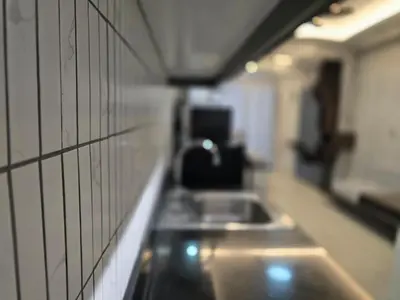 a kitchen counter with a sink on a wall at Stonewood Suite by Staycationplus with FREE PARKING in Manila