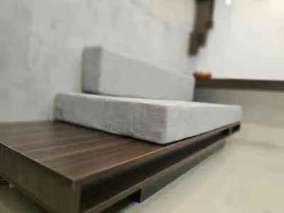 a bed sitting on top of a wooden table at Stonewood Suite by Staycationplus with FREE PARKING in Manila