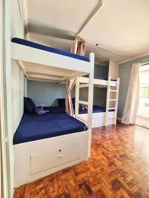 a bedroom with two bunk beds and a wooden floor at 16 Guest for Group at Palm Tower 2 Makati RM 203 in Manila