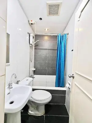 a small bathroom with a toilet and a sink at 16 Guest for Group at Palm Tower 2 Makati RM 203 in Manila