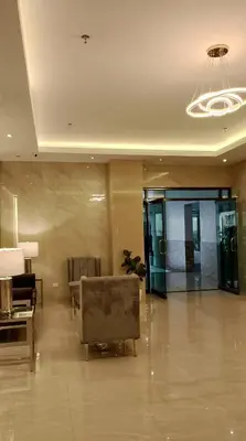 a lobby with a couch and a chair in a building at 16 Guest for Group at Palm Tower 2 Makati RM 203 in Manila