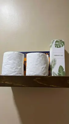 a shelf with two towels and a box on it at Empirestatecation at Leaf Residences in Manila