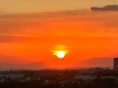 a sunset over a city with the sun in the sky at 1BR Condotel in Azure Urban Resort near NAIA #TRO1 in Manila