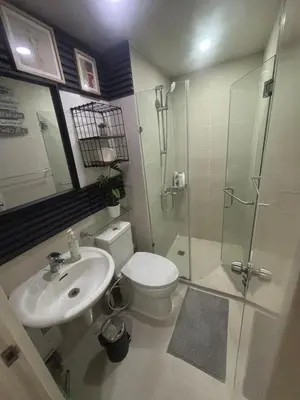 a bathroom with a toilet and a shower and a sink at 1BR Condotel in Azure Urban Resort near NAIA #TRO1 in Manila