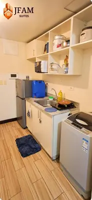 a kitchen with a sink and a refrigerator at JFam Suites, C4-10R Studio, Up To 4 Pax in Biñan