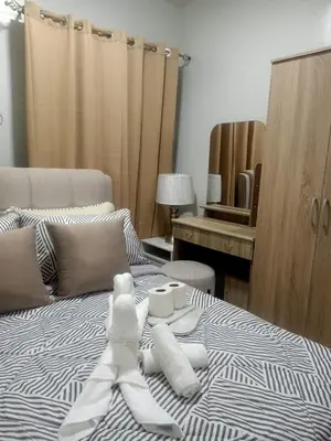 a bed with white towels on top of it at Coho Staycation with Free swimming in Las Pinas in Manila