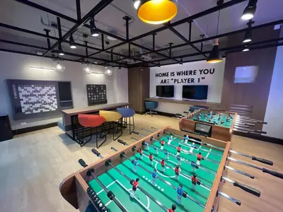 a room with a swimming pool with tables and chairs at Lovely 1BR near Solaire, Okada I 5mins to Airport in Manila