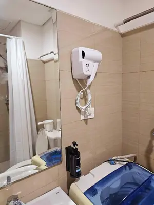 a bathroom with a mirror and a toilet and a camera at Hannah's Crib at Shore Residences with Balcony and Pool View in Manila