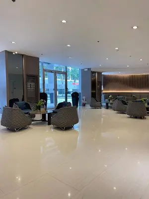 a lobby with chairs and tables in a building at Hannah's Crib at Shore Residences with Balcony and Pool View in Manila