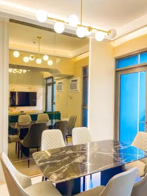 a dining room with a table and chairs at Lovely 2br near Airport, Solaire, & Okada - 6pax in Manila