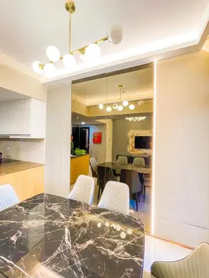 a kitchen and dining room with a table and chairs at Lovely 2br near Airport, Solaire, & Okada - 6pax in Manila
