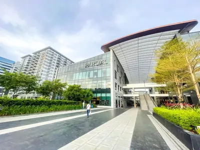 a person walking in front of a building at Lovely 2br near Airport, Solaire, & Okada - 6pax in Manila