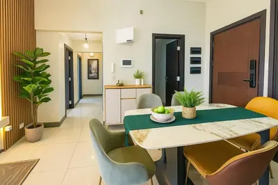a kitchen and dining room with a table and chairs at Rare 3BR Modern Penthouse in BGC II Sleeps 12pax in Manila