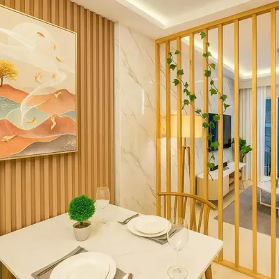 a dining room with a white table and chairs at Stylish & Cozy 1 bedroom near Mall of Asia in Manila