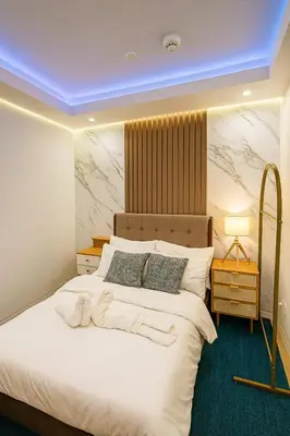 a bedroom with a large white bed with aavidavascript at Stylish & Cozy 1 bedroom near Mall of Asia in Manila
