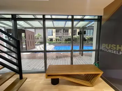 a room with a bench in front of a building at Lovely 2 bedroom near Airport & Okada in Manila