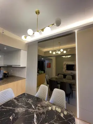 a kitchen and dining room with a table and chairs at Lovely 2 bedroom near Airport & Okada in Manila