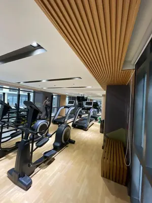 a gym with treadmills and elliptical machines at Lovely 2 bedroom near Airport & Okada in Manila