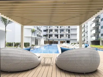 a patio with two bean chairs and a swimming pool at Savea Bay City Manila in Manila