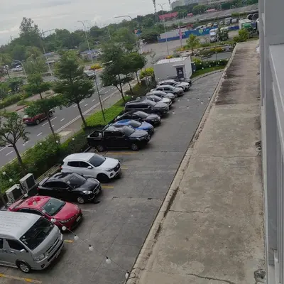 a row of cars parked in a parking lot at Shore Residences Near Moa in Manila