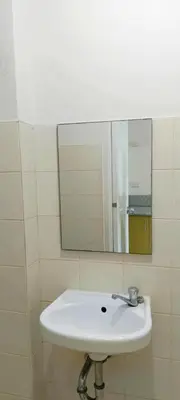 a white sink in a bathroom with a mirror at The Grand Towers Manila in Manila