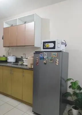a kitchen with a refrigerator with magnets on it at The Grand Towers Manila in Manila