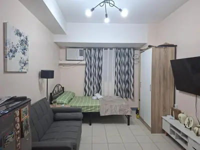 a small living room with a couch and a table at The Grand Towers Manila in Manila