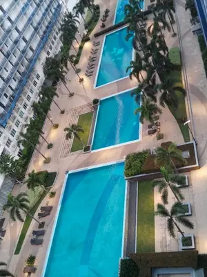 an aerial view of a building with palm trees at MOA Sea Residences Condotel in Manila