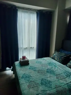 a bedroom with a bed and a window at Rqui Family Room Pasay City in Manila