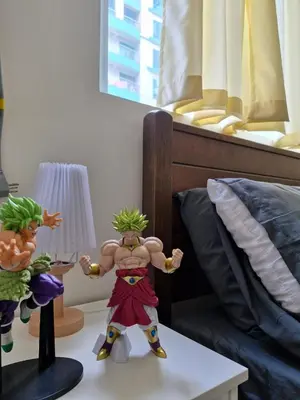 a toy figure standing on a table next to a bed at Your 2BR within Pasay in Manila