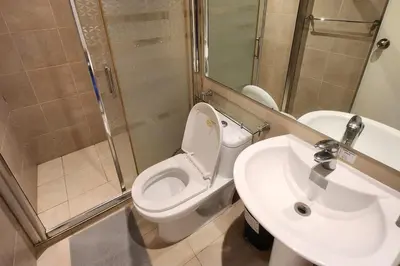 a bathroom with a toilet and a sink at Green City View Apt in Gramercy Unit 3502 Makati w Netflix in Manila