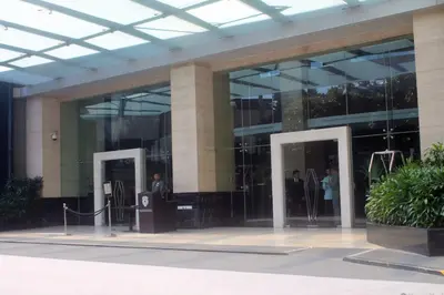 a large glass building with people standing outside of it at Green City View Apt in Gramercy Unit 3502 Makati w Netflix in Manila