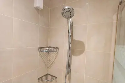 a shower with a shower head in a bathroom at Green City View Apt in Gramercy Unit 3502 Makati w Netflix in Manila