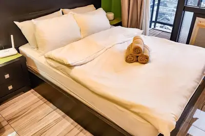 a bed with two towels on top of it at Green City View Apt in Gramercy Unit 3502 Makati w Netflix in Manila