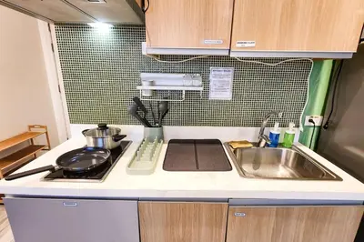 a small kitchen with a sink and a stove at Green City View Apt in Gramercy Unit 3502 Makati w Netflix in Manila