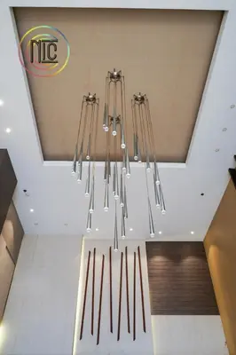 a chandelier hanging from the ceiling in a building at Cozy 2BR UnitN Free Pool Gym with Karaoke Netflix in Manila