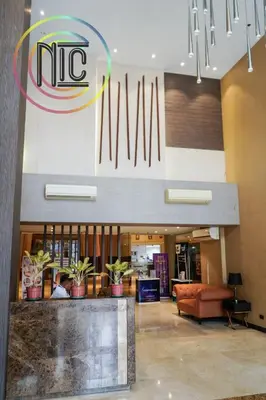 a lobby with a mtc sign on the wall at Cozy 2BR UnitN Free Pool Gym with Karaoke Netflix in Manila