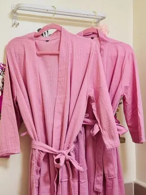 a pink robe is hanging on a rack at Boogsh Coquette Vibes Staycation In Pasig! in Manila