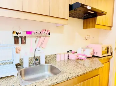 a kitchen counter with a sink and a microwave at Boogsh Coquette Vibes Staycation In Pasig! in Manila