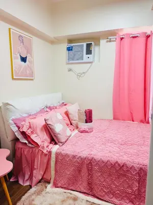 a bedroom with a pink bed with pink sheets at Boogsh Coquette Vibes Staycation In Pasig! in Manila