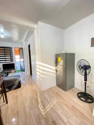 a room with a refrigerator and a room with a table at Cabuhat Duco Lodge 31 in Tanza