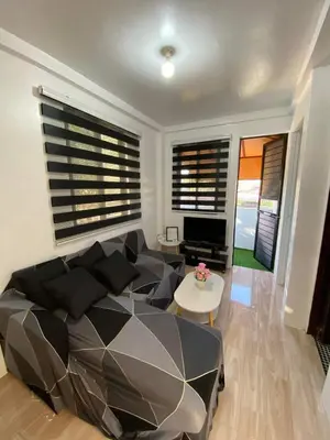 a living room with a couch and a table at Cabuhat Duco Lodge 31 in Tanza